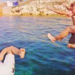 friends jumping in water