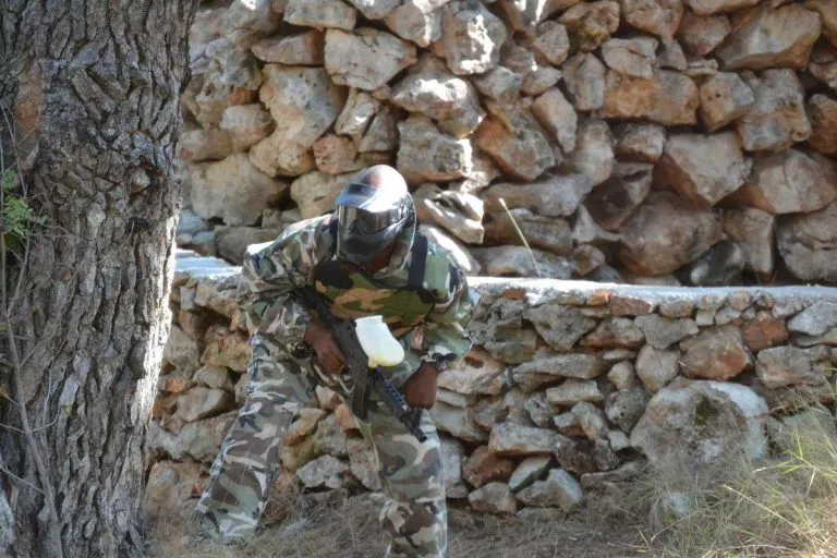 paintball hiding behind tree